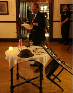 Comrade Bill Thibault explaining the significance of the table set for our fallen & missing comrades. Photo credit: Gary Donovan